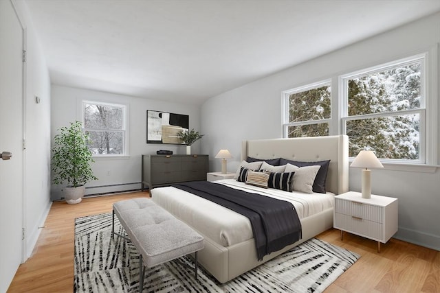 bedroom featuring light hardwood / wood-style floors and a baseboard radiator