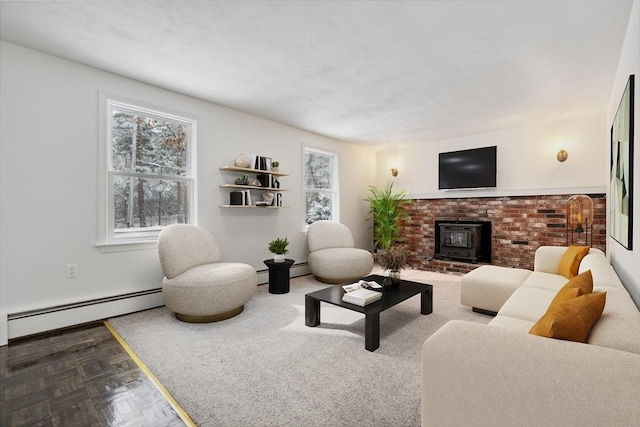 living room featuring a wood stove, parquet floors, and a baseboard heating unit