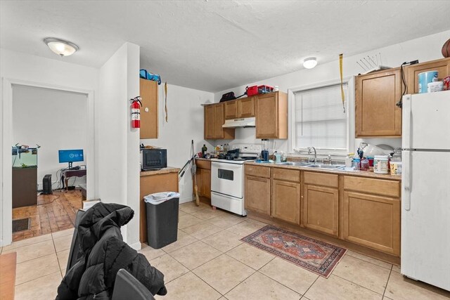 15 Russell St, Worcester, MA 01609 - kitchen featuring white appliances, under cabinet range hood, a sink, light tile patterned floors, and light countertops