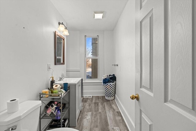 15 Russell St, Worcester, MA 01609 - bathroom with vanity, toilet, wood finished floors, and baseboards