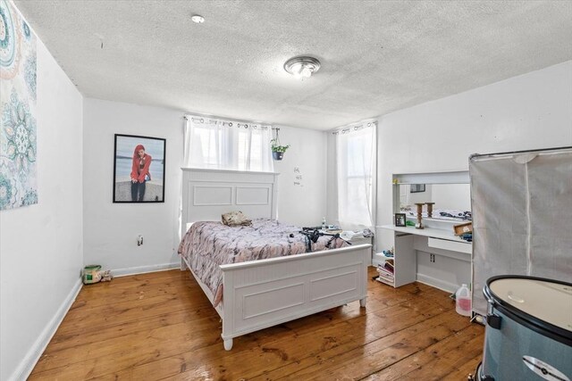 15 Russell St, Worcester, MA 01609 - bedroom with hardwood / wood-style flooring, a textured ceiling, and baseboards