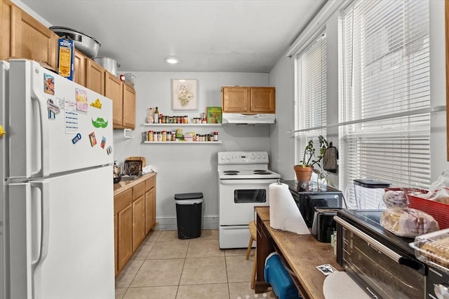 15 Russell St, Worcester, MA 01609 - kitchen with white appliances, under cabinet range hood, light tile patterned flooring, baseboards, and recessed lighting