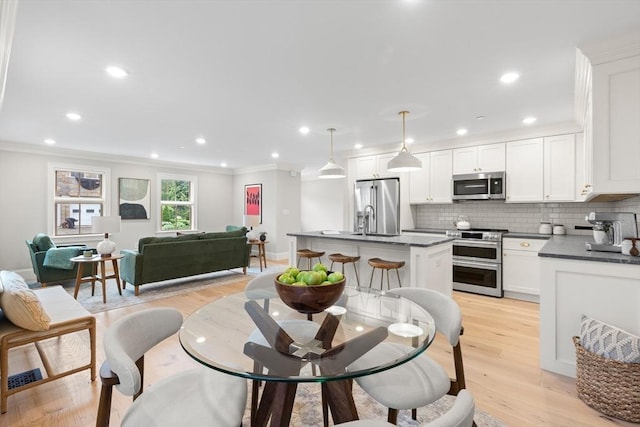 36 Broadway Unit 0, Rockport, MA 01966 - dining space with crown molding, light wood finished floors, and recessed lighting