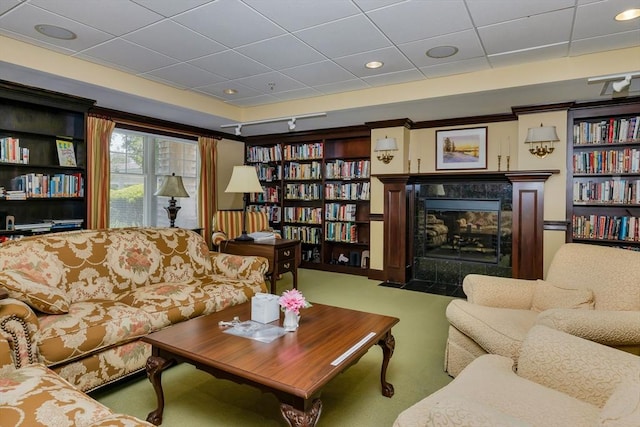 110 Dillingham Ave Unit 212, Falmouth, MA 02540 - living area featuring a tiled fireplace, carpet, and a paneled ceiling