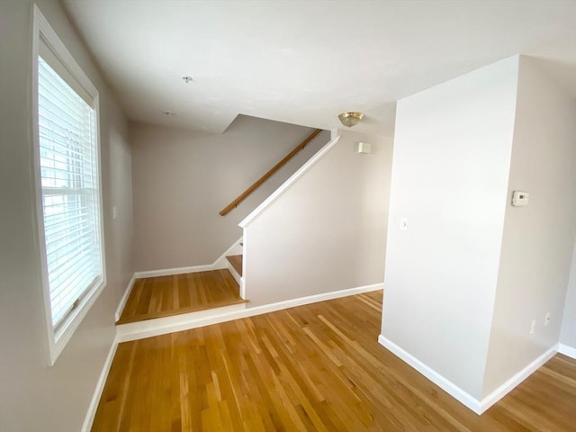 interior space with baseboards and wood finished floors