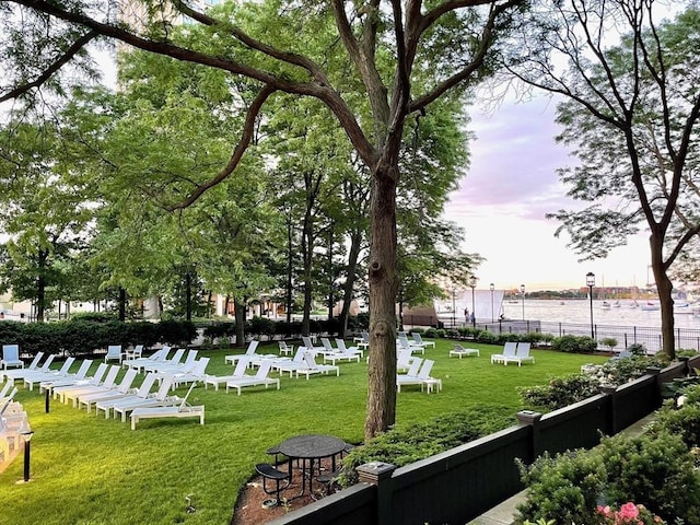 view of property's community featuring a water view and a yard