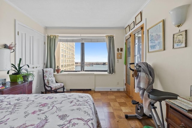 bedroom featuring crown molding, a closet, a water view, and light parquet floors