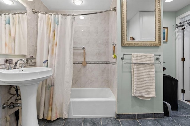 bathroom with shower / tub combo with curtain and sink