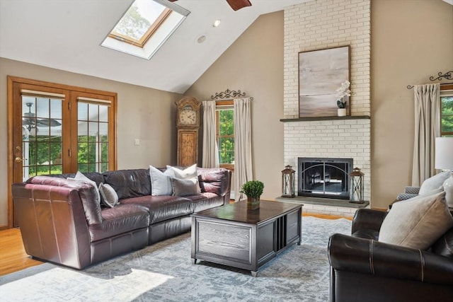 5 Red Tail Run, Canton, MA 02021 - living area with a skylight, a brick fireplace, a ceiling fan, and high vaulted ceiling