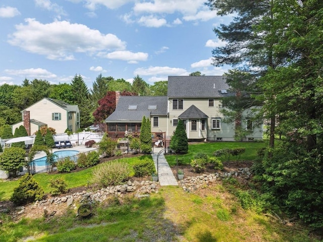 5 Red Tail Run, Canton, MA 02021 - view of front of home featuring an outdoor pool, a sunroom, a patio area, roof with shingles, and a chimney