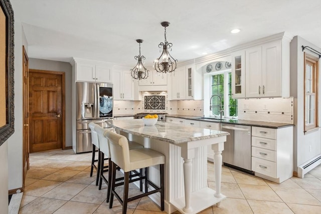 5 Red Tail Run, Canton, MA 02021 - kitchen with appliances with stainless steel finishes, a sink, white cabinets, a breakfast bar, and decorative backsplash