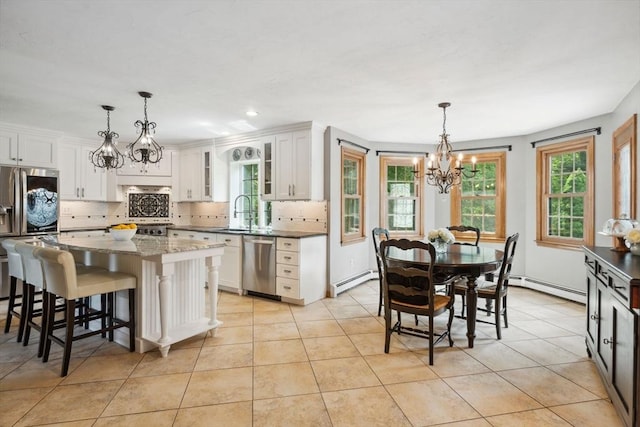 5 Red Tail Run, Canton, MA 02021 - kitchen featuring appliances with stainless steel finishes, a chandelier, white cabinetry, backsplash, and a sink