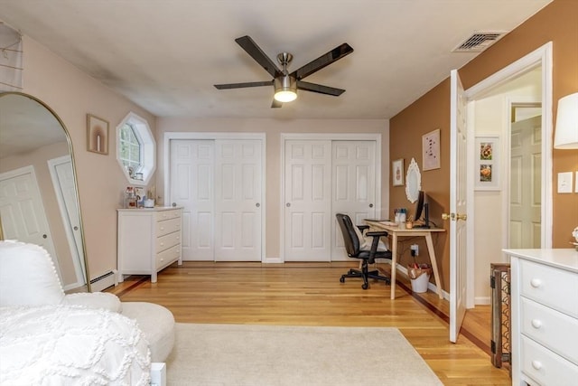 50 Kienia Rd, Hudson, NH 03051 - bedroom with two closets, light wood-style floors, an office area, and a baseboard heating unit