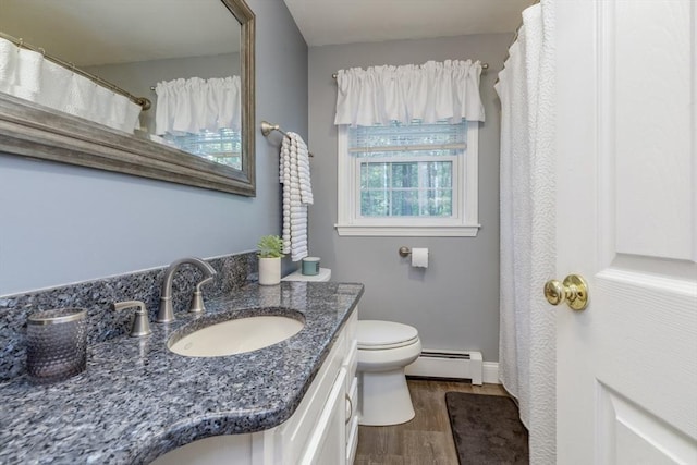 50 Kienia Rd, Hudson, NH 03051 - bathroom with baseboard heating, wood finished floors, vanity, toilet, and baseboards