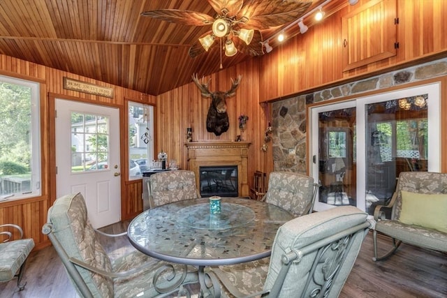 50 Kienia Rd, Hudson, NH 03051 - dining room featuring wooden ceiling, wood walls, lofted ceiling, wood finished floors, and a glass covered fireplace