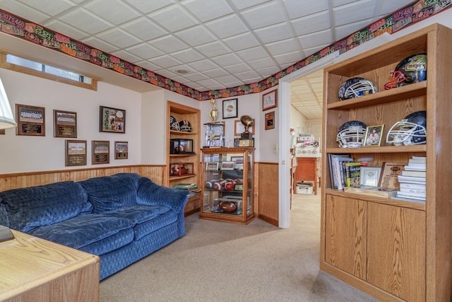 50 Kienia Rd, Hudson, NH 03051 - living room featuring wainscoting, wooden walls, carpet flooring, and built in shelves