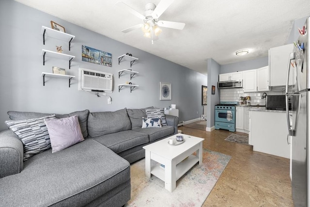 151 W 6th St Unit 1, Boston, MA 02127 - living room with a wall unit AC, ceiling fan, concrete flooring, and baseboards