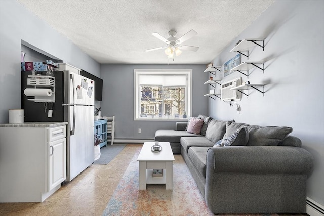 151 W 6th St Unit 1, Boston, MA 02127 - living area featuring baseboard heating, a ceiling fan, a wall unit AC, and a textured ceiling