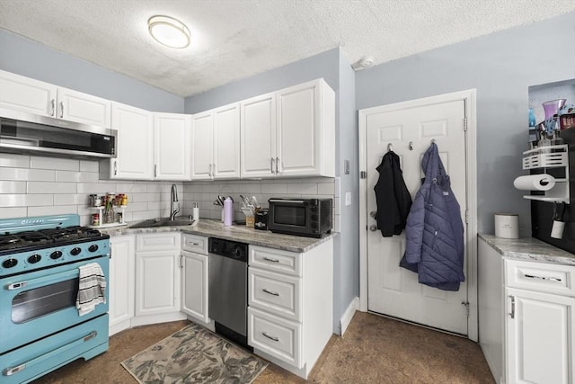 151 W 6th St Unit 1, Boston, MA 02127 - kitchen with appliances with stainless steel finishes, a sink, dark carpet, white cabinets, and a textured ceiling