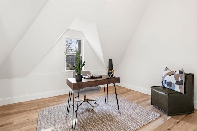 office with light hardwood / wood-style floors and vaulted ceiling