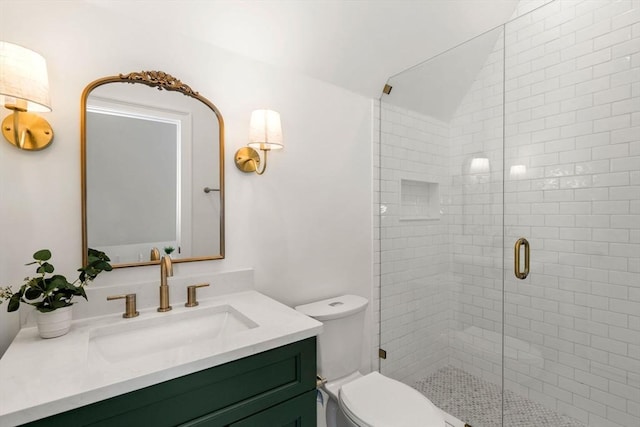 bathroom featuring walk in shower, vanity, and toilet