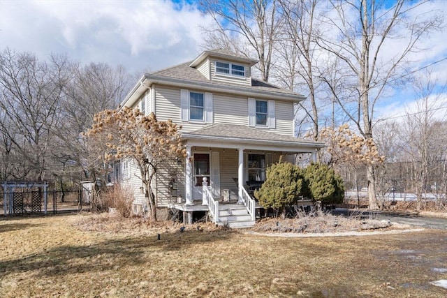 view of front of house with a porch and a front yard