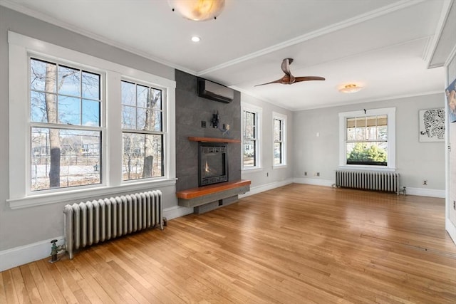 living room with ornamental molding, a fireplace, and radiator