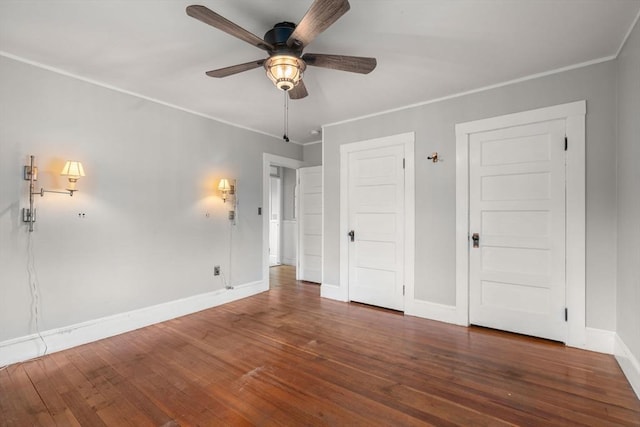 spare room featuring ceiling fan, ornamental molding, and dark hardwood / wood-style floors