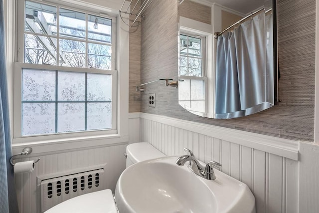 bathroom with plenty of natural light, sink, and radiator heating unit