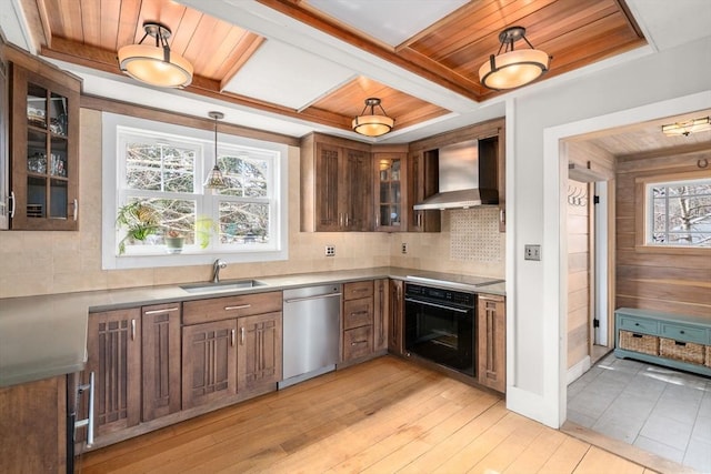 kitchen featuring wooden ceiling, wall chimney range hood, and black appliances