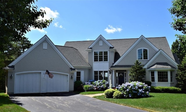 view of front of house featuring a garage and a front lawn