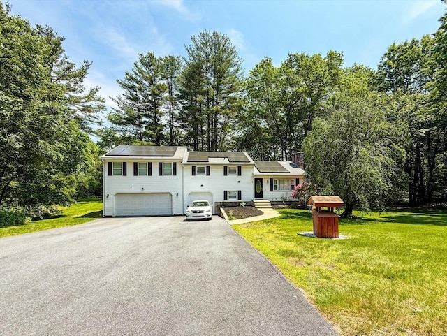 1 Fieldstone Way, Hopedale, MA 01747 - split level home with a garage, driveway, a front lawn, and roof mounted solar panels