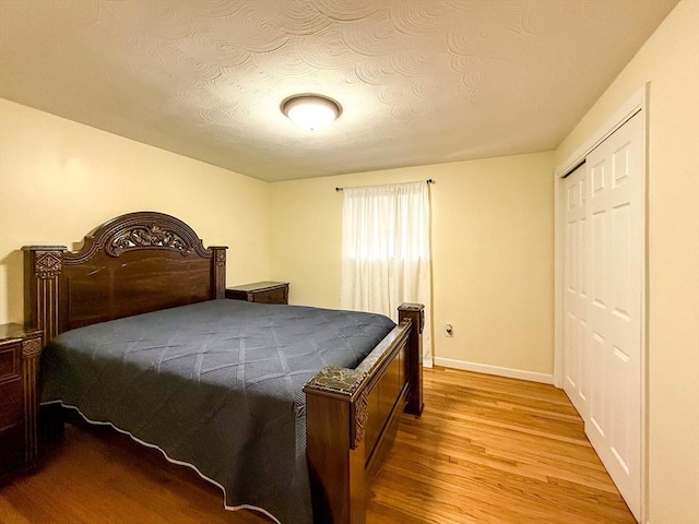 1 Fieldstone Way, Hopedale, MA 01747 - bedroom featuring light wood-type flooring, baseboards, a closet, and a textured ceiling