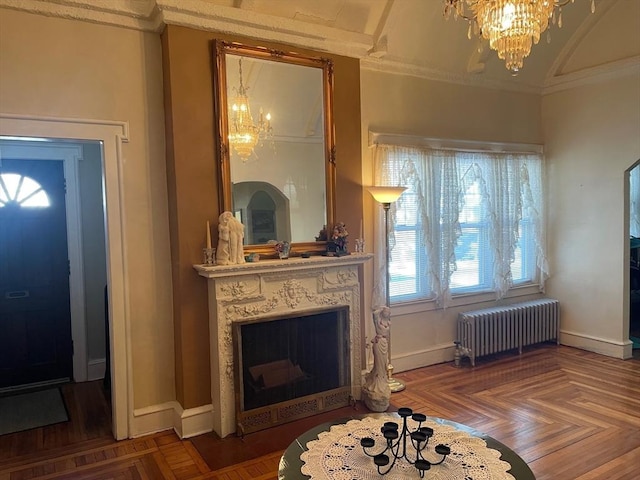 interior space with an inviting chandelier, parquet floors, and radiator heating unit