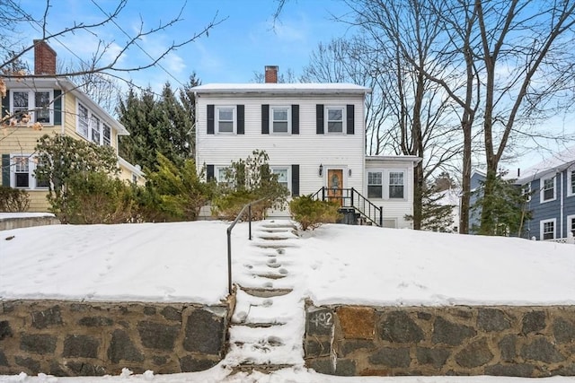 colonial-style house with a chimney