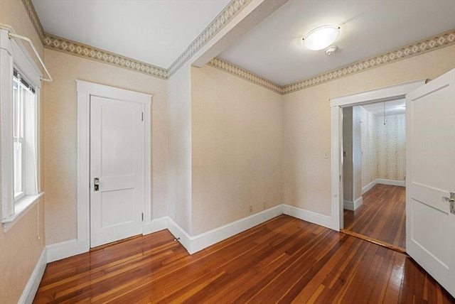 entrance foyer featuring dark wood-type flooring and baseboards