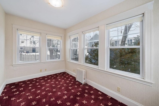 unfurnished sunroom featuring radiator heating unit