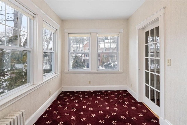 unfurnished sunroom featuring radiator