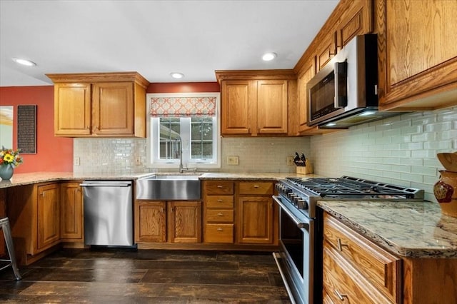 7 Scenic Dr, Wilbraham, MA 01095 - kitchen with stainless steel appliances, brown cabinetry, dark wood finished floors, light stone countertops, and recessed lighting