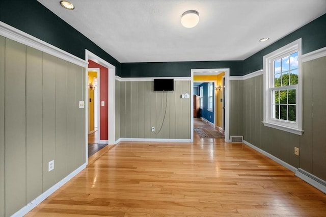 7 Scenic Dr, Wilbraham, MA 01095 - unfurnished room with wood finished floors and a baseboard heating unit
