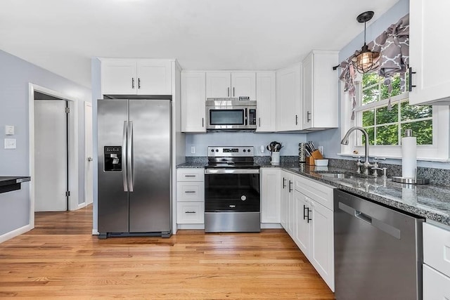66 Barnum St, Taunton, MA 02780 - kitchen featuring stainless steel appliances, white cabinetry, and dark stone countertops