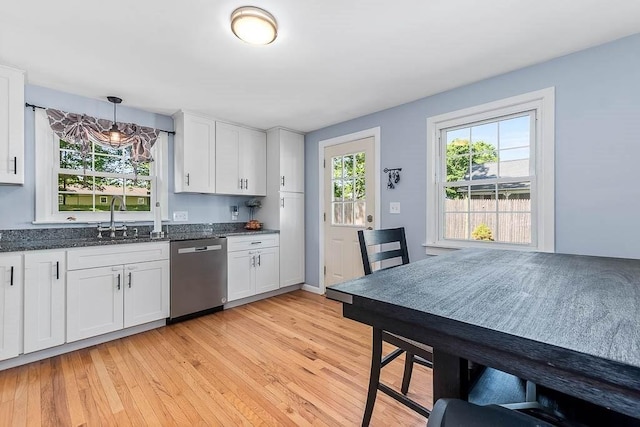 66 Barnum St, Taunton, MA 02780 - kitchen featuring stainless steel dishwasher, white cabinetry, light wood-style floors, and dark stone counters