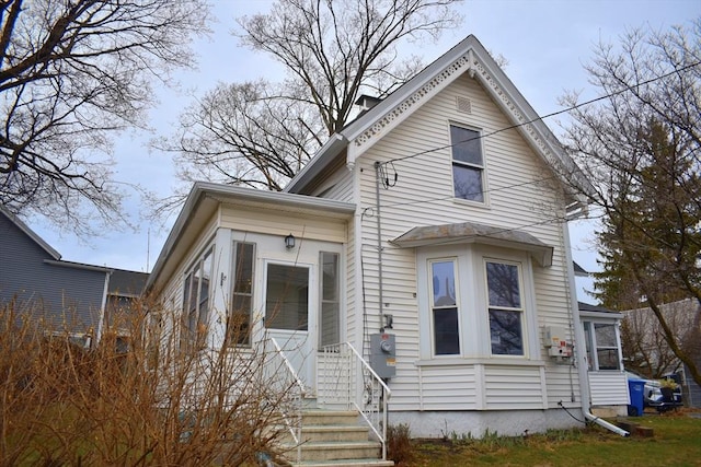 view of front of property featuring a sunroom