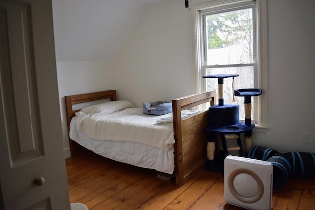 bedroom featuring wood-type flooring and lofted ceiling