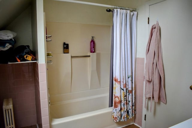 full bath with shower / bath combo with shower curtain and radiator