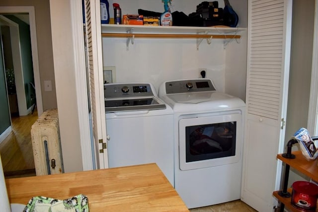 laundry room featuring independent washer and dryer, laundry area, and radiator