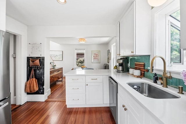16 Desmond Ave, Manchester, MA 01944 - kitchen with a peninsula, plenty of natural light, light countertops, and white cabinetry