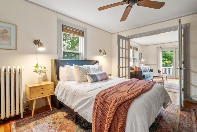 16 Desmond Ave, Manchester, MA 01944 - bedroom featuring radiator, wood finished floors, access to exterior, and french doors