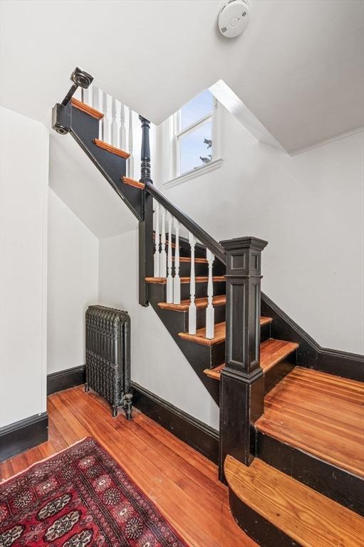 16 Desmond Ave, Manchester, MA 01944 - stairway with radiator heating unit and wood finished floors