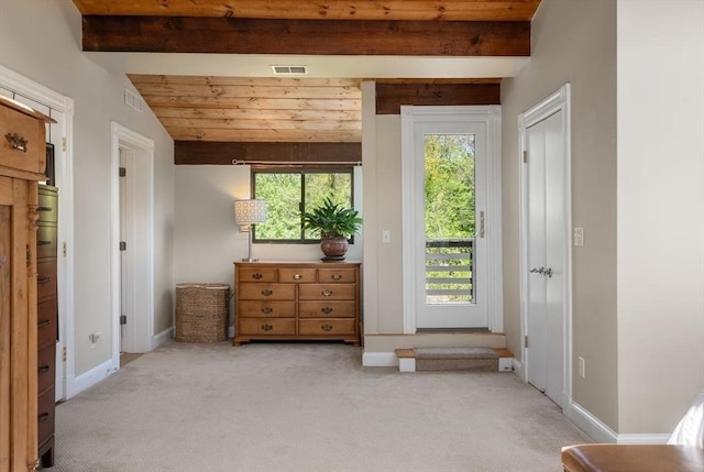 bedroom with access to exterior, light carpet, multiple windows, beam ceiling, and baseboards